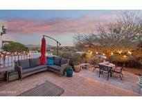 Outdoor patio featuring cozy seating, a table, and a vibrant umbrella, ideal for relaxing and enjoying mountain views at 15510 E Sycamore Dr, Fountain Hills, AZ 85268