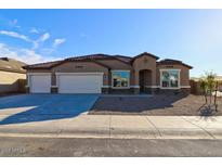 Charming single-story home with a three-car garage and desert landscaping at 17735 W Brown St, Waddell, AZ 85355