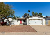 Charming single-story home featuring a bright red front door and a well-maintained two-car garage at 1974 E Vinedo Ln, Tempe, AZ 85284