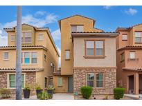 Charming two-story home featuring stone accents and well-maintained landscaping under a bright blue sky at 2013 N 77Th Gln, Phoenix, AZ 85035