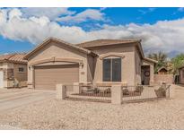 Charming single-story home featuring a stucco exterior, well-maintained landscaping, and attached two-car garage at 20916 E Desert Hills Blvd, Queen Creek, AZ 85142