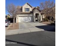 Charming two-story home featuring a two-car garage and stone entryway, complemented by desert landscaping at 2730 E Vermont Dr, Gilbert, AZ 85295