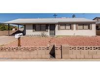 Charming single-story home featuring desert landscaping and a quaint picket fence, adding to its curb appeal at 2928 W Cactus Rd, Phoenix, AZ 85029