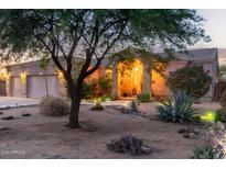 Charming single-story home featuring an arched entryway, desert landscaping, and a 2-car garage at 38301 N 15Th Ave, Phoenix, AZ 85086