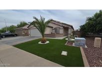 Charming single-story home featuring a well-manicured front yard, desert landscaping, and a two car garage at 4546 N 84Th Ln, Phoenix, AZ 85037