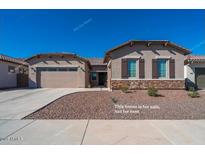 Charming single-story home featuring a two-car garage and low-maintenance desert landscaping at 7234 S 28Th Ln, Phoenix, AZ 85041