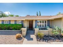 Charming single-story home featuring a manicured front yard and a welcoming front entrance at 725 E Country Gables Dr, Phoenix, AZ 85022