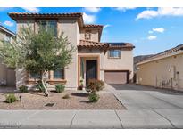 Charming two-story home featuring a tile roof, low maintenance desert landscaping, and an attached two car garage at 7428 W Montgomery Rd, Peoria, AZ 85383