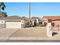 Charming single-story home with desert landscaping and a two-car garage in a sunny locale at 9138 E Emerald Dr, Sun Lakes, AZ 85248