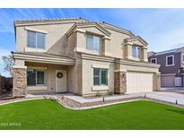 Two-story home featuring an attached two-car garage, desert landscaping, and stone accents around the porch pillars at 9574 W Quail Ave, Peoria, AZ 85382