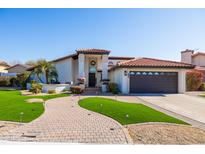 Inviting single-story home featuring manicured landscaping, a red-tile roof, and a covered front entryway at 1501 N Lesueur --, Mesa, AZ 85203