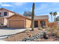 Charming single-story home with desert landscaping and a two car garage, with bright blue sky at 15853 S 17Th Dr, Phoenix, AZ 85045