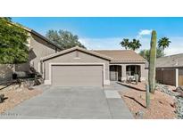 Charming single-story home featuring a two-car garage and desert landscaping at 15853 S 17Th Dr, Phoenix, AZ 85045