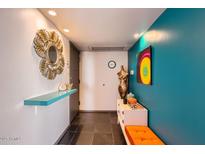 Bright entryway with colorful decor and modern accents offers a stylish welcome to the home at 207 W Clarendon Ave # G18, Phoenix, AZ 85013