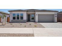 Charming single-story home with a neutral color palette, low-maintenance landscaping, and a two-car garage at 22685 E Saddle Way, Queen Creek, AZ 85142