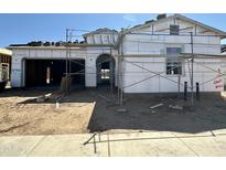 New home construction with scaffolding featuring a garage and covered entrance; exterior walls are framed at 22693 E Saddle Way, Queen Creek, AZ 85142