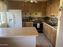 Charming kitchen featuring wooden cabinetry and countertops, and modern appliances at 2530 W Berridge Ln # E201, Phoenix, AZ 85017