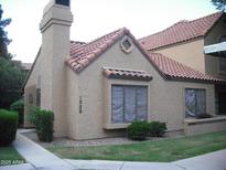 Charming single-story home featuring a red tile roof, stucco siding and a well-maintained front yard at 5704 E Aire Libre Ave # 1036, Scottsdale, AZ 85254
