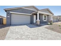 Charming home featuring a two-car garage and a well-manicured front yard and walkway at 7701 W Avenida Del Rey --, Peoria, AZ 85383