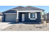 Charming single-story home with a gray exterior, stone accents, and low maintenance desert landscaping at 7701 W Avenida Del Rey --, Peoria, AZ 85383