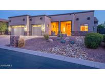 Charming single-story home featuring a two-car garage and desert landscaping at 8541 E Canyon Estates Cir, Gold Canyon, AZ 85118