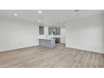 Bright living room featuring modern gray cabinets, light wood floors and recessed lighting at 1250 E Wood St # 28, Phoenix, AZ 85040