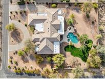 Stunning aerial view of a luxury home showcasing a pristine pool, lush landscaping, and ample parking at 13126 E Turquoise Ave, Scottsdale, AZ 85259