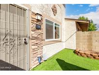 View of the front entrance with a secure door and rock features adding to the curb appeal at 1316 N 85Th Pl, Scottsdale, AZ 85257