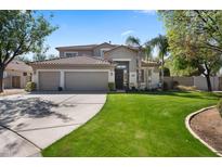 Charming home featuring a three-car garage and lush green lawn, perfect for curb appeal at 1427 E Palomino Dr, Gilbert, AZ 85296