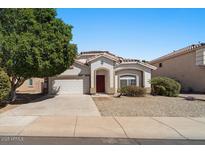 Charming single-story home featuring a two car garage and low maintenance landscaping at 15822 W Boca Raton Rd, Surprise, AZ 85379