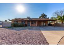 Charming single-story home with a covered porch and low-maintenance desert landscaping at 306 N Winthrop Cir, Mesa, AZ 85213