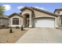 Inviting single-Gathering home featuring a tile roof, neutral stucco exterior, and low-maintenance desert landscaping at 40360 W Hayden Dr, Maricopa, AZ 85138