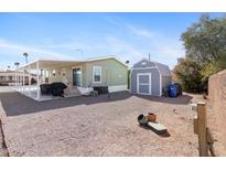 Spacious backyard with patio, BBQ, storage shed and desert landscaping for relaxing and entertaining outdoors at 7807 E Main St # Cc-98, Mesa, AZ 85207