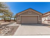 Beautiful home featuring a two-car garage, complemented by desert-friendly landscaping at 9644 N 97Th Ln, Peoria, AZ 85345