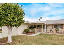 Charming single-story home featuring a well-manicured lawn and decorative front yard fence at 10516 W El Capitan Cir, Sun City, AZ 85351