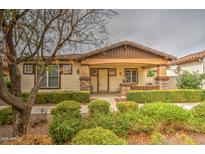 Charming single-story home with a covered porch, manicured landscaping, and a welcoming facade at 1155 S Annie Ln, Gilbert, AZ 85296