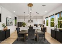 Open floor plan featuring a dining area with a modern chandelier and kitchen island at 15577 S 181St Ln, Goodyear, AZ 85338