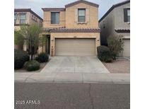 Two-story home featuring a well maintained lawn, a large 2-car garage, and desert landscaping at 1562 W Lacewood Pl, Phoenix, AZ 85045