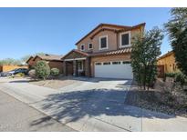 Charming two-story home featuring a two car garage and meticulously landscaped front yard at 1713 W Cottonwood Ln, Phoenix, AZ 85045