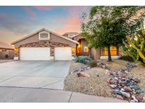 Charming single-Gathering home featuring a three-car garage and desert landscaping at 20640 N 100Th Ln, Peoria, AZ 85382