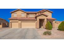 Spacious home with a three-car garage and well-maintained front yard and appealing desert landscaping at 224 N 236Th Ave, Buckeye, AZ 85396