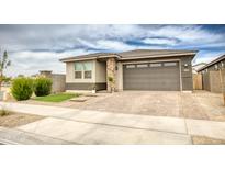 Charming single-story home featuring a two-car garage and low-maintenance desert landscaping at 22474 E Lawndale E Pl, Queen Creek, AZ 85142