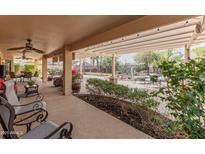 Inviting covered patio with ample seating and lush landscaping, perfect for outdoor relaxation and entertainment at 2612 N 161St Ave, Goodyear, AZ 85395