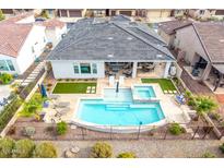 Aerial view of the backyard pool and jacuzzi, covered patio and fenced yard at 4319 W Winslow Way, Eloy, AZ 85131