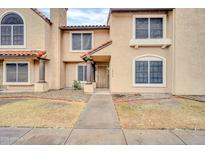 Charming two-story townhome with desert landscaping and a welcoming entrance at 4601 N 102Nd Ave # 1036, Phoenix, AZ 85037