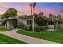 Charming single-story home with a beautifully landscaped front yard, walkway, and lush greenery at 4800 N 68Th St # 109, Scottsdale, AZ 85251