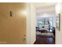 Hallway leading into a bright living room with hardwood floors and a gray rug at 7121 E Rancho Vista Dr # 3001, Scottsdale, AZ 85251