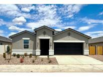Charming single-story home with a well-manicured yard and a two-car garage at 8486 W Mantle Way, Florence, AZ 85132