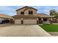 Two-story home showcasing a three-car garage and a well-manicured lawn at 9627 W Reno View Dr, Peoria, AZ 85345