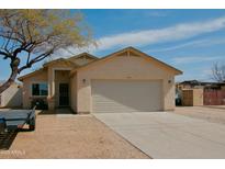 Charming single-story home with a two-car garage and desert landscaping at 1815 S San Marcos Dr, Apache Junction, AZ 85120